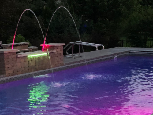 pool with waterfall spouts and lighting