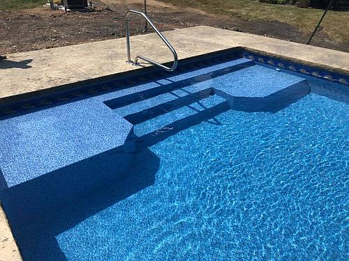 Pool Stairs and large sundeck by Swim Shack
